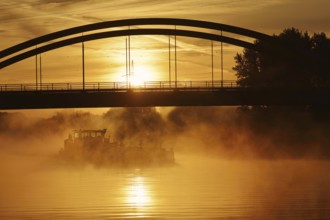 Ship on the Datteln-Hamm Canal in the morning fog at sunrise, Bergkamen, North Rhine-Westphalia,