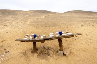 Pink salt displayed on wooden stands along the road to Namib-Naukluft National Park and Sandwich