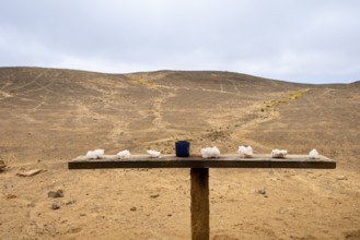 Pink salt displayed on wooden stands along the road to Namib-Naukluft National Park and Sandwich