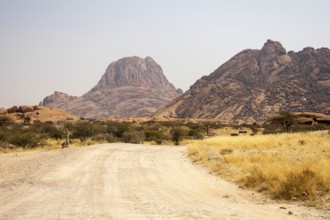 Granite peaks and rugged desert landscape at Spitzkoppe Community Campsite, Namibia. Golden