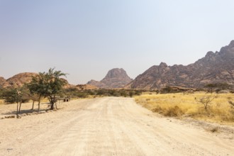 Granite peaks and rugged desert landscape at Spitzkoppe Community Campsite, Namibia. Golden