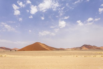 Sossusvlei in Namibia is a desert wonder, famous for its giant red dunes, glowing at sunrise and