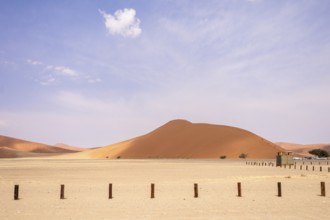 Sossusvlei in Namibia is a desert wonder, famous for its giant red dunes, glowing at sunrise and