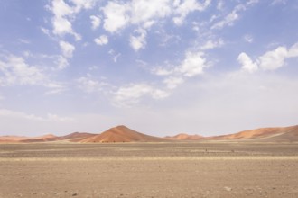 Sossusvlei in Namibia is a desert wonder, famous for its giant red dunes, glowing at sunrise and