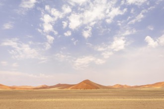 Sossusvlei in Namibia is a desert wonder, famous for its giant red dunes, glowing at sunrise and