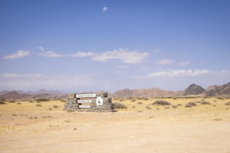 Stone entrance sign of Namib-Naukluft National Park in Namibia- 27 August, 2025: surrounded by
