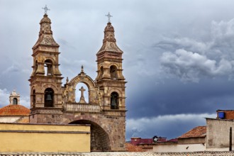 Historic church with imposing spires against a dramatic, cloudy sky, Cathedral spires over the city