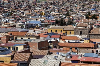 A multitude of densely packed buildings with colourful roofs in a lively urban area, view over the