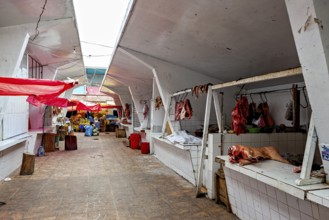 Covered market area with various stalls and an aisle in the centre, The meat market in the market