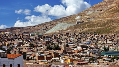 City view with many brick houses at the foot of the hills under a blue sky, The silver mountain