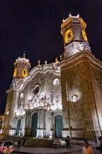 Illuminated church at night with decorative lighting effects and passers-by, The churches of the