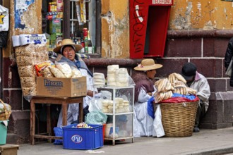 Women selling traditional food at a street stall in Peru, Bolivian Indio woman selling goods in the