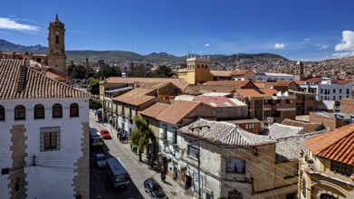 Central square of the city with church towers and mountains in the background, The streets of the