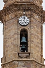 Stone bell tower with clock and bell, architecturally decorated, The churches of the city of Potosi