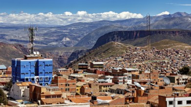 Urban landscape with red tiled roof architecture and a telecommunications tower in front of a
