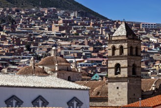 Historic cityscape with towers and densely built-up areas under a blue sky, view over the city of