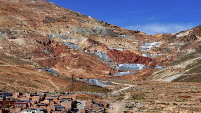 Reddish mountain landscape with visible mines under a clear sky, the Cerro Rico silver mountain in