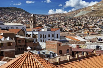 City view with different roof structures and a mountain landscape in the background, view over the