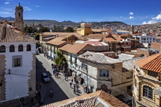Urban view with church tower and busy street, The streets of the historic centre of Potosi in