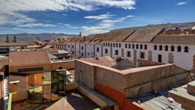 Urban view with tiled roofs under a clear blue sky, The streets of the historic centre of Potosi in