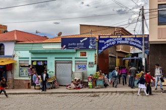 Entrance to a market with fruit stalls and passers-by, people in the streets of Potosi in Bolivia