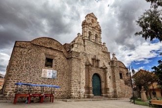 Historic church with imposing stone walls and baroque details under a cloudy sky, The old churches