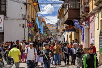 Busy old town street full of people in sunny weather, people in the streets of Potosi in Bolivia