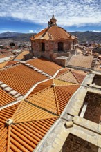 Detailed architecture with striking roof tiles, embedded in a mountain landscape, The roof of