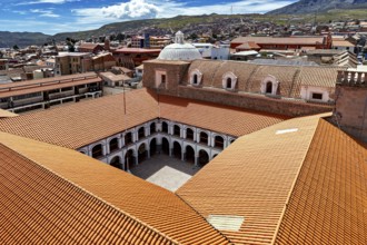 Architectural courtyard of a monastery with tiled roofs in a city, view over the city of Potosi in