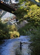 The Wuppertal suspension railway over the riverbed of the Wupper near the Kluse stop, Wuppertal,