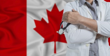 Doctor with stethoscope on arm with Canada flag behind. National health system of Canada, concept