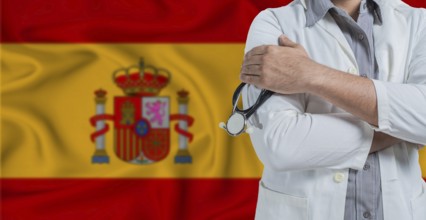 Doctor with stethoscope on arm with Spain flag behind. National health system of Spain, concept