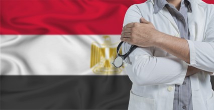 Doctor with stethoscope on arm with Egypt flag behind. National health system of Egypt, concept