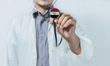 Egypt national healthcare. Doctor showing stethoscope with Egypt flag
