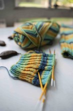 Coloured wool with started knitted sock
