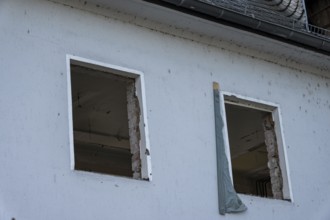 Building wall with empty window openings during house renovation or construction project