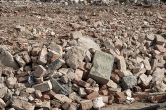 Accumulation of broken bricks and concrete from construction demolition site