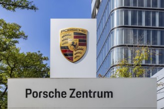 Porsche Centre Autohaus am Pragsattel. Porsche Design Tower skyscraper. Logo on a stele. Stuttgart,