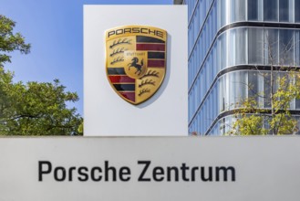 Porsche Centre Autohaus am Pragsattel. Porsche Design Tower skyscraper. Logo on a stele. Stuttgart,