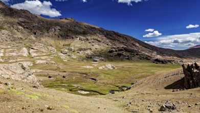Vast, mountainous landscape under a clear blue sky with white clouds, The landscape near Potosi in