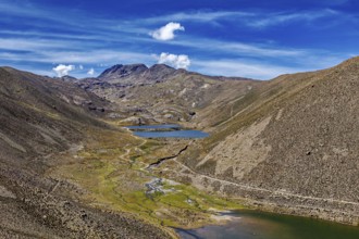 Valleys and rivers wind through mountainous terrain under a blue sky, The landscape near Potosi in