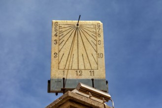 Classic stone sundial with clear dial and hands against a sunny background, The sundial of Potosi