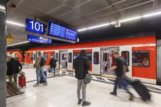 S-Bahn arriving underground at the main station stop. Platform with travellers. Stuttgart,