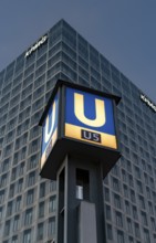The picture shows a modern high-rise building in Berlin with the KPMG logo and a striking