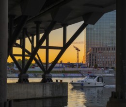A view of the Berlin waterfront promenade at Humboldt harbour at sunset with modern architecture