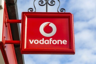 Vodafone sign with logo on shopfront of Vodafone phone shop, Marlborough, Wiltshire, England, UK