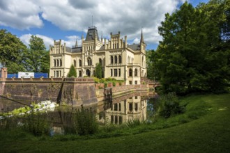 Gothic castle in perspective with moat surrounded by green landscape, Evenburg Castle, Leer, East