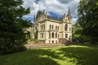 A Gothic castle with towers and lawns in summery surroundings, Schloss Evenburg, Leer, East Frisia