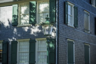 Side view of a building with green shutters, old lantern and shadow play, Friedrich Engels House in