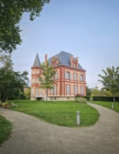 The Castel Rose in L'Isle-Adam, France. Historic mansion characterized by its pink walls and